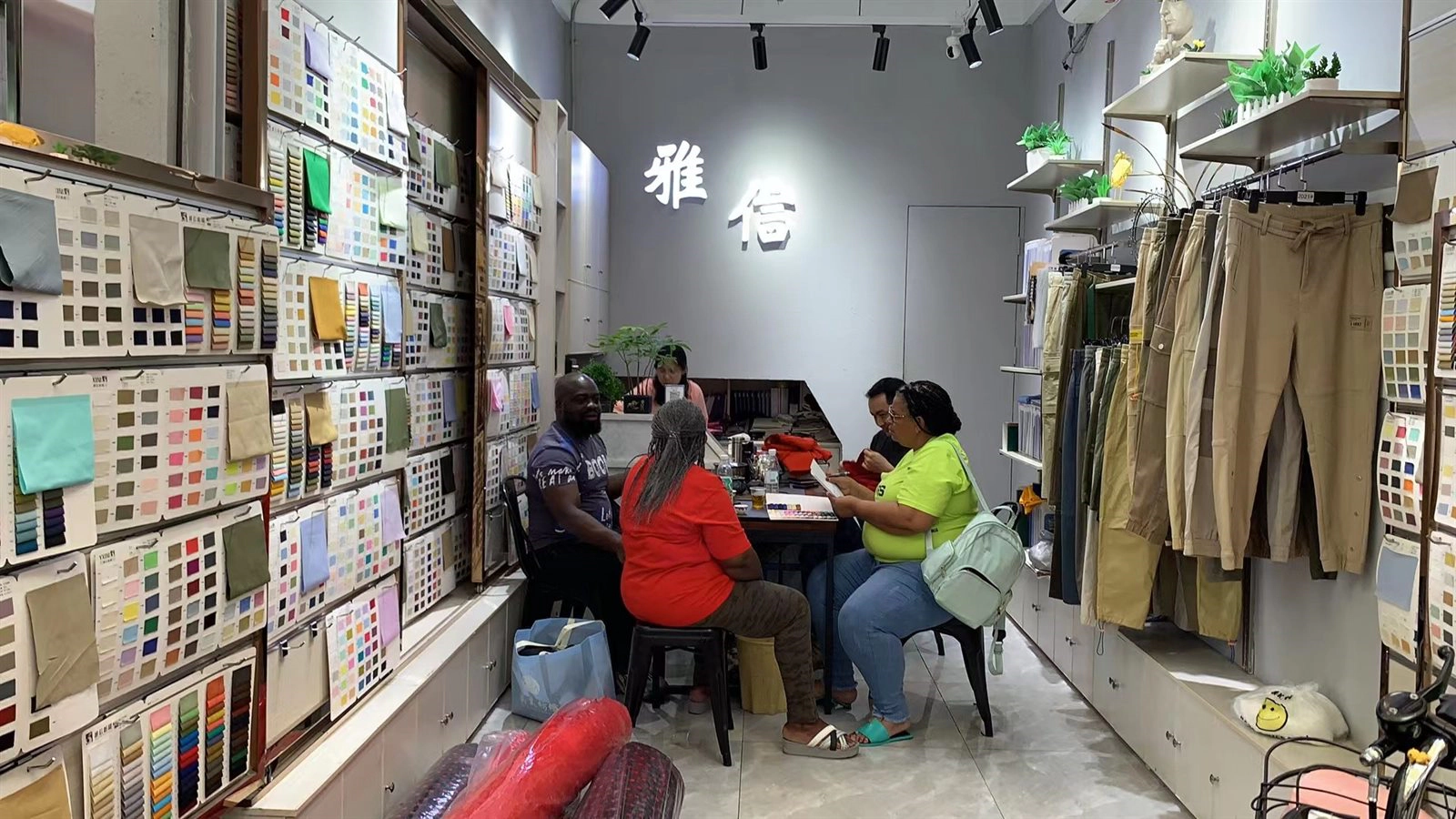 Overseas buyers reviewing fabrics in the YAQIXIN Guangzhou showroom