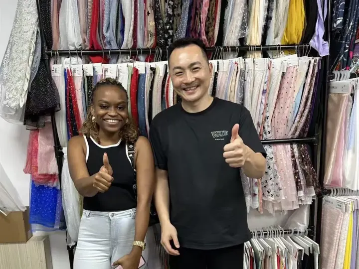 Buyer confirming fabric options with YAQIXIN textile team